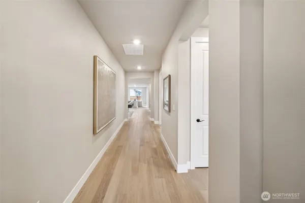 a view of a hallway with wooden floor