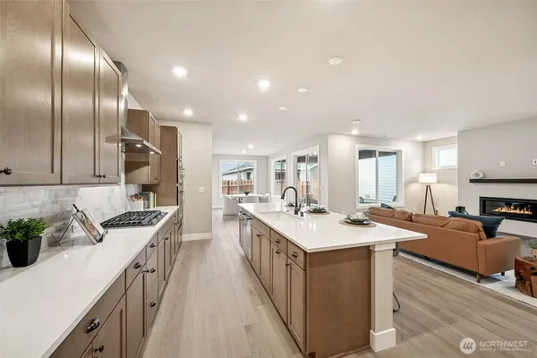 a kitchen with stainless steel appliances granite countertop a sink a stove and a refrigerator