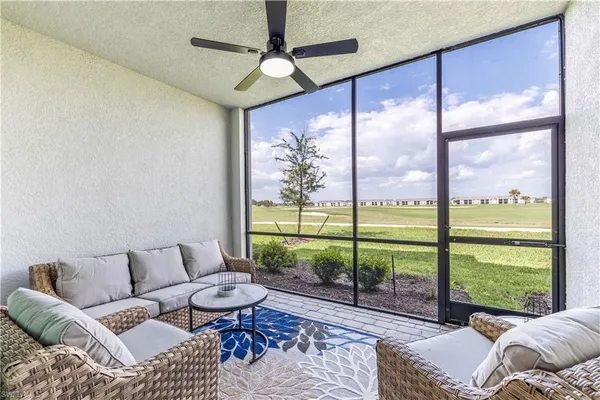 a living room with furniture and a floor to ceiling window