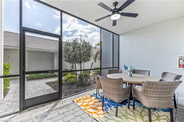 a view of a dining room with furniture wooden floor and a potted plant