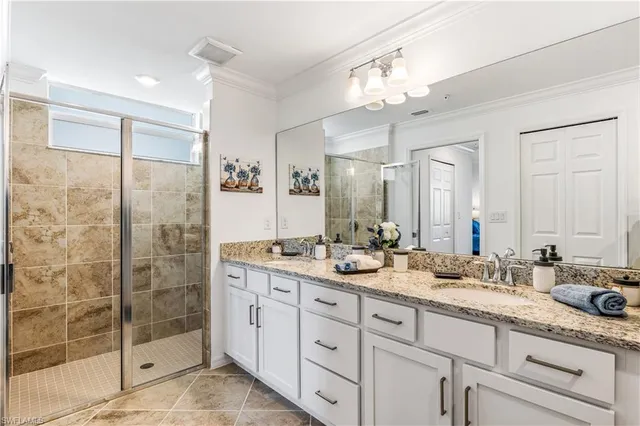 a bathroom with double sink and a mirror