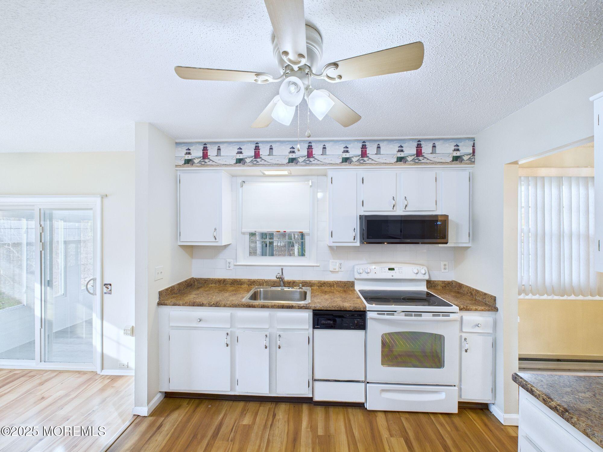 10 Hartford Road Manchester Township, NJ 08759 - Photo 13 of 35 a kitchen with a stove a sink and a refrigerator