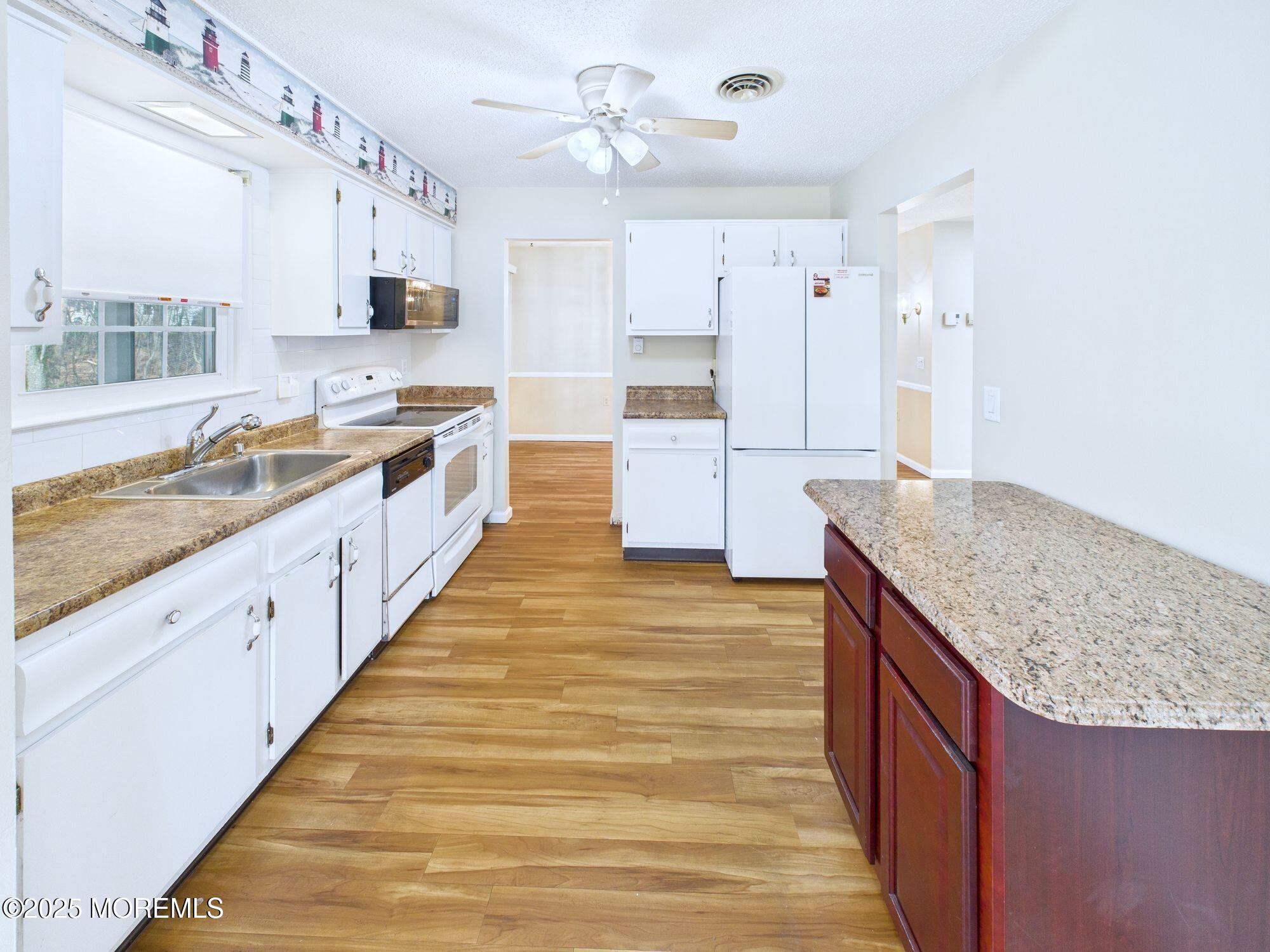 10 Hartford Road Manchester Township, NJ 08759 - Photo 15 of 35 a large kitchen with kitchen island a sink stainless steel appliances and cabinets