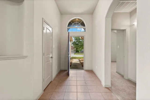 a view of a hallway to rooms