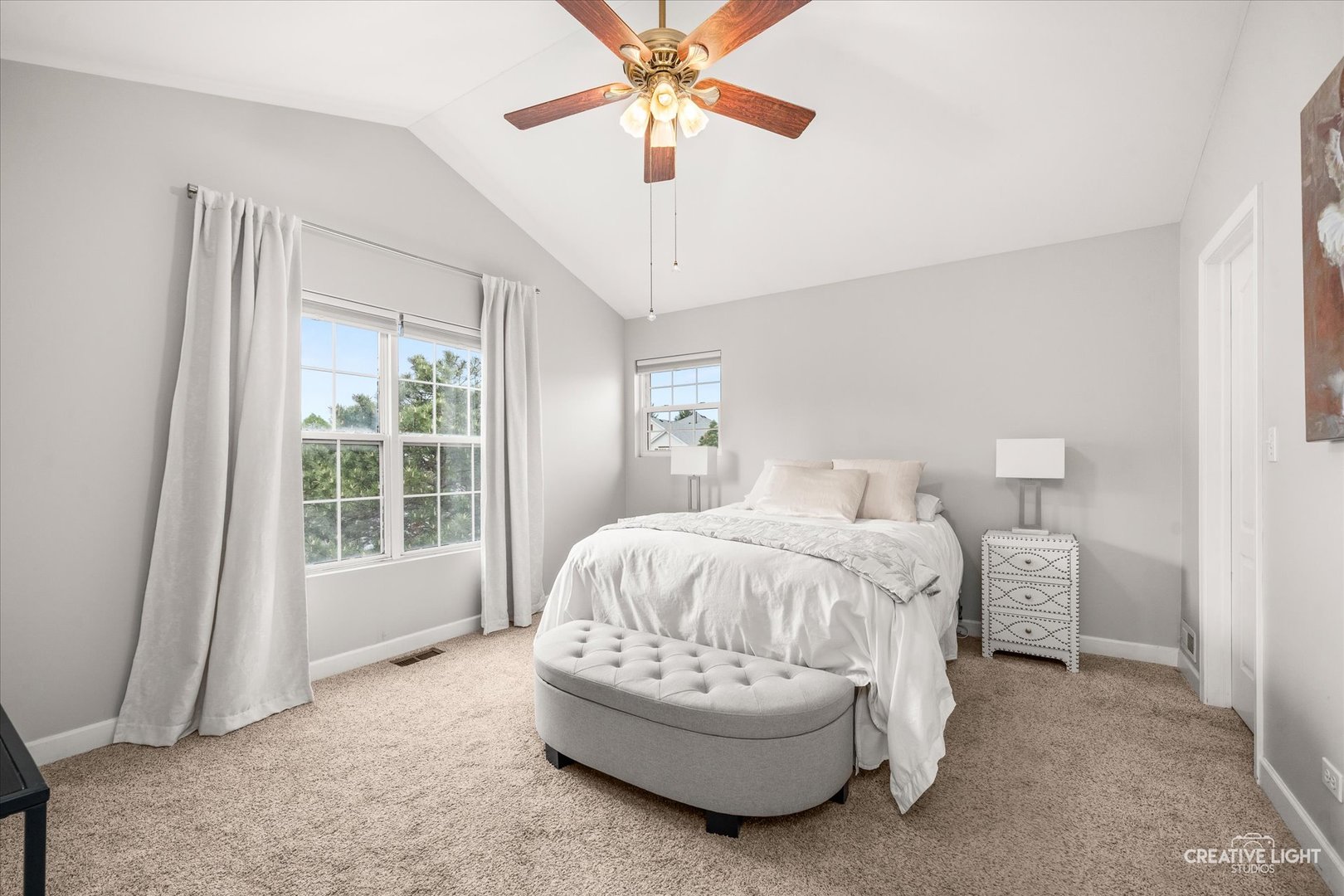 24019 Pear Tree Circle Plainfield, IL 60585 - Photo 13 of 20 a spacious bedroom with a bed and a chandelier