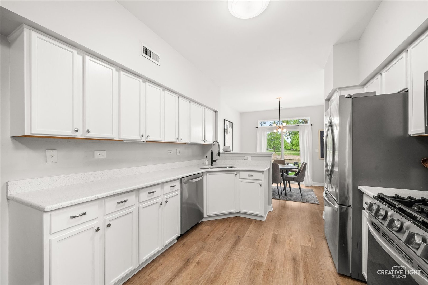 24019 Pear Tree Circle Plainfield, IL 60585 - Photo 6 of 20 a kitchen with white cabinets and appliances