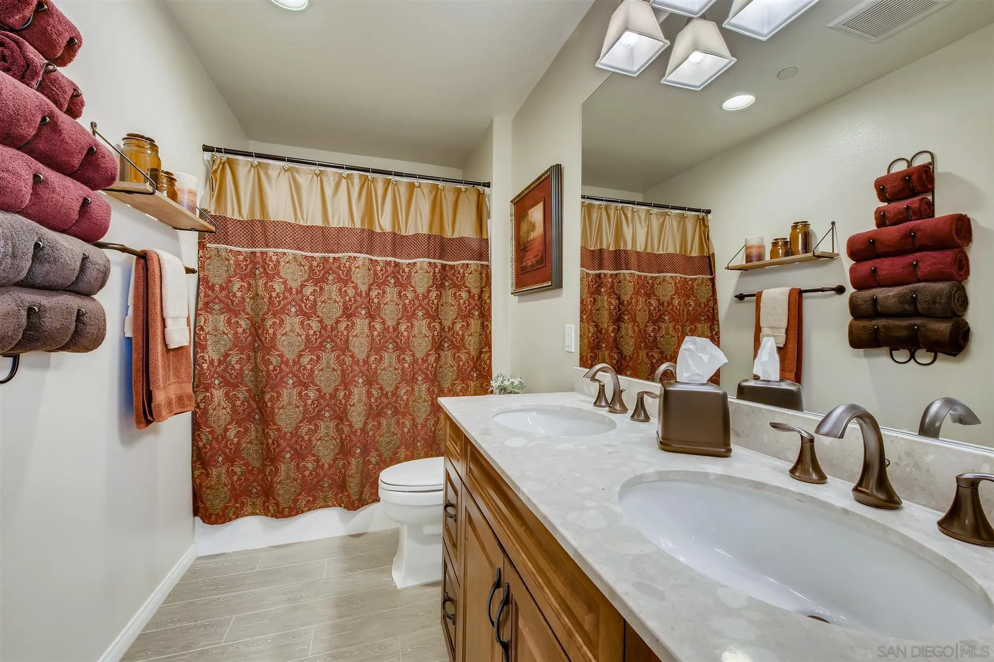8629 Orchard Bloom Way El Cajon, CA 92021 - Photo 14 of 19 a bathroom with a granite countertop sink a toilet and shower curtain