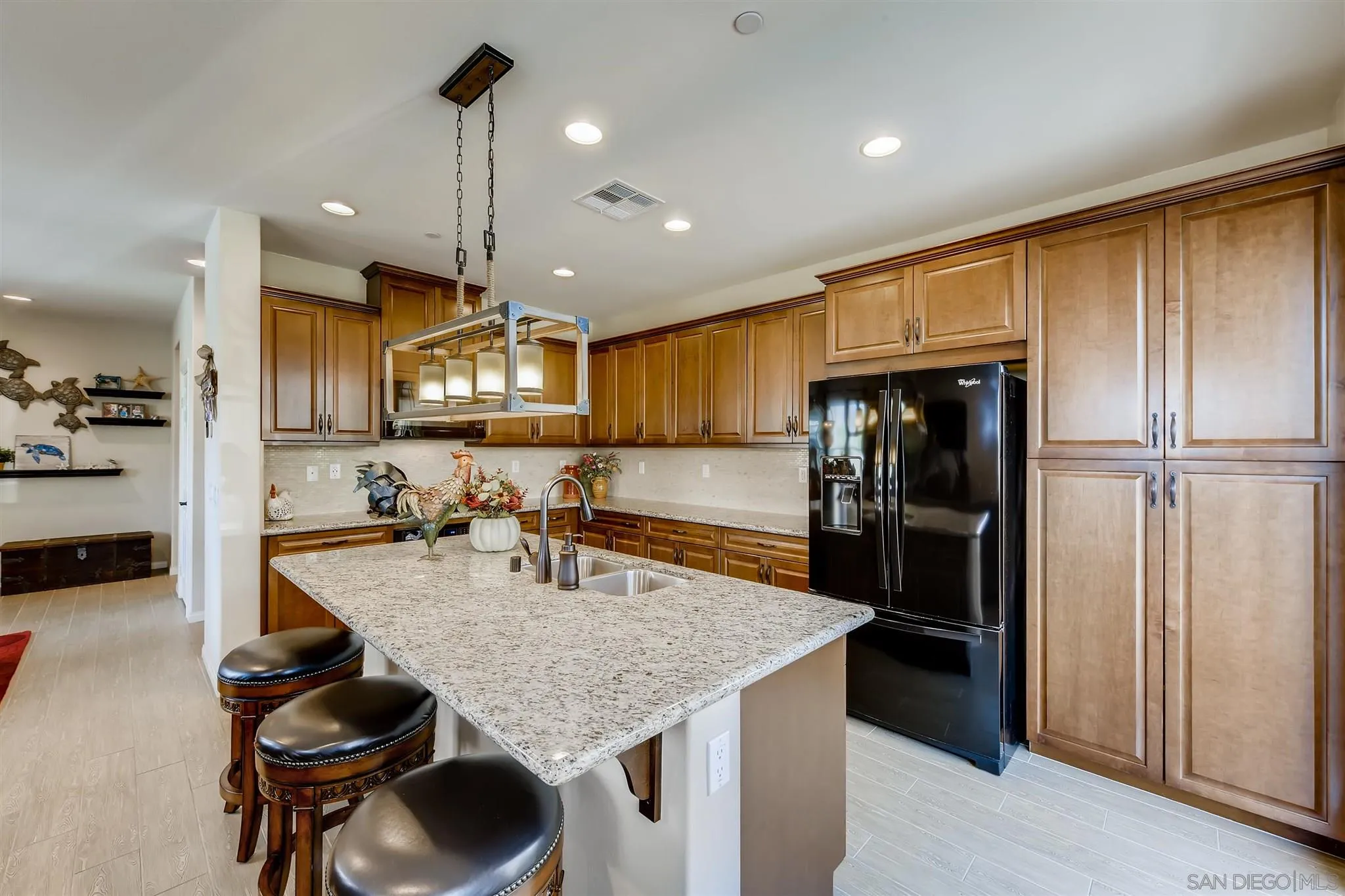 8629 Orchard Bloom Way El Cajon, CA 92021 - Photo 5 of 19 a kitchen with refrigerator a sink and chairs