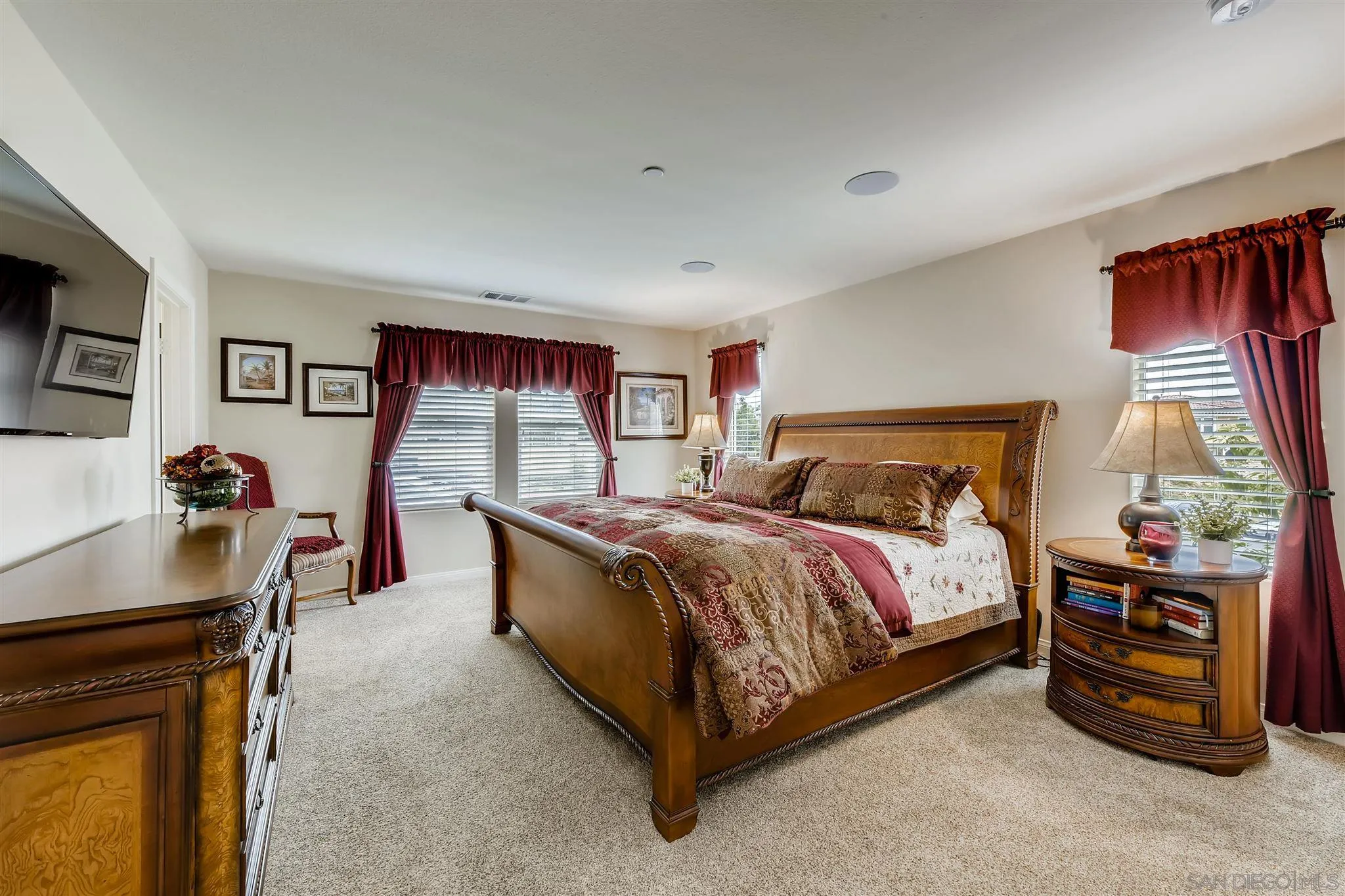 8629 Orchard Bloom Way El Cajon, CA 92021 - Photo 8 of 19 a bedroom with a bed and a flat tv screen on dresser