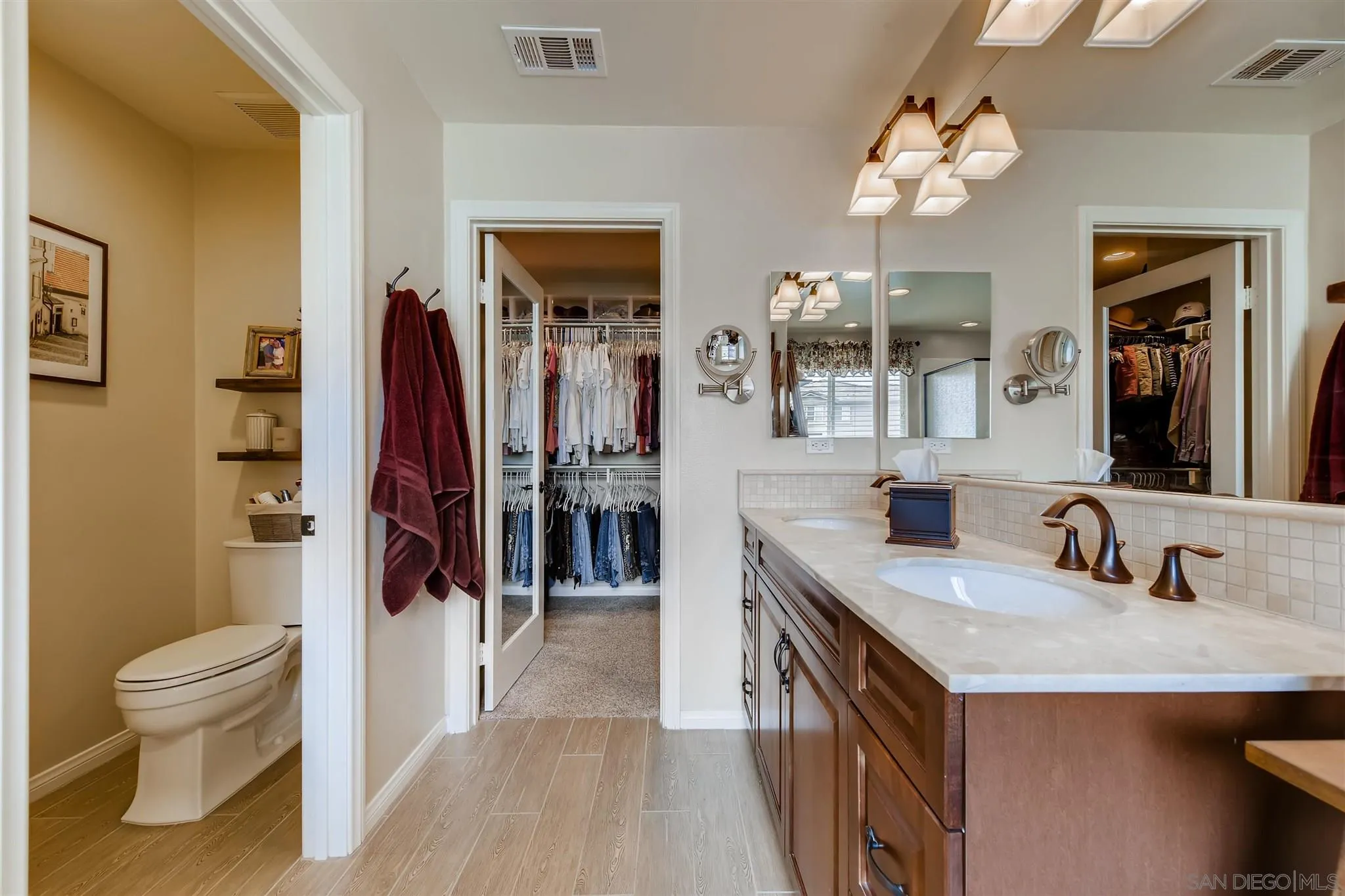 8629 Orchard Bloom Way El Cajon, CA 92021 - Photo 9 of 19 a en suite bathroom with a granite countertop sink a toilet a mirror and shower