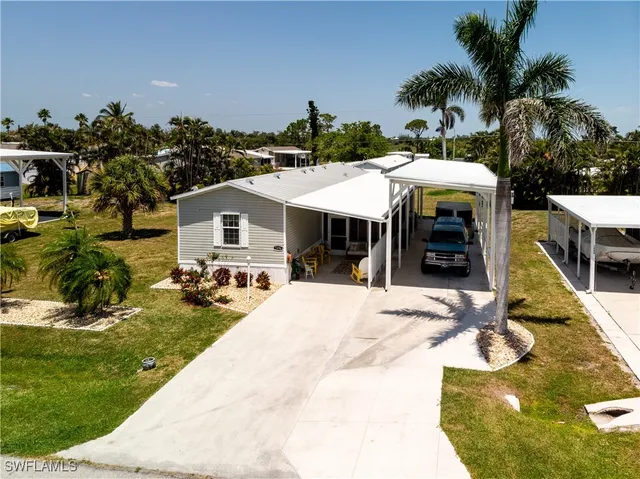 a view of a house with swimming pool and sitting area