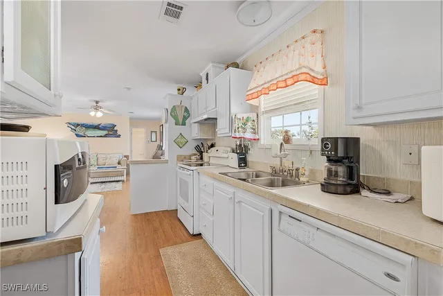 a kitchen with sink cabinets and window