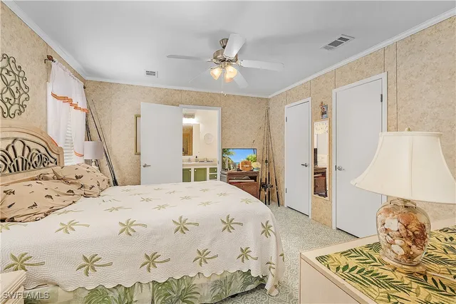 a spacious bedroom with a bed and a chandelier