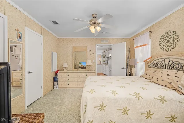 a spacious bedroom with a large bed and a chandelier