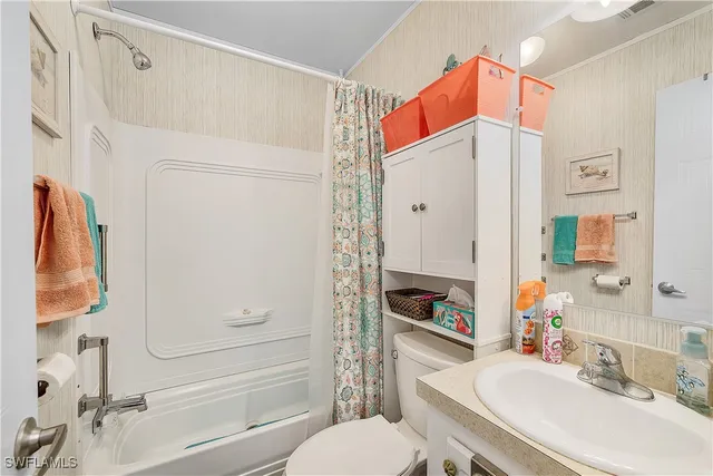 a bathroom with a sink vanity mirror and shower