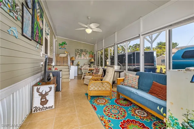 a living room with furniture and a floor to ceiling window