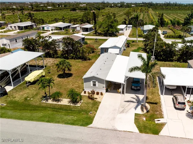 an aerial view of a house with a yard basket ball court and outdoor seating