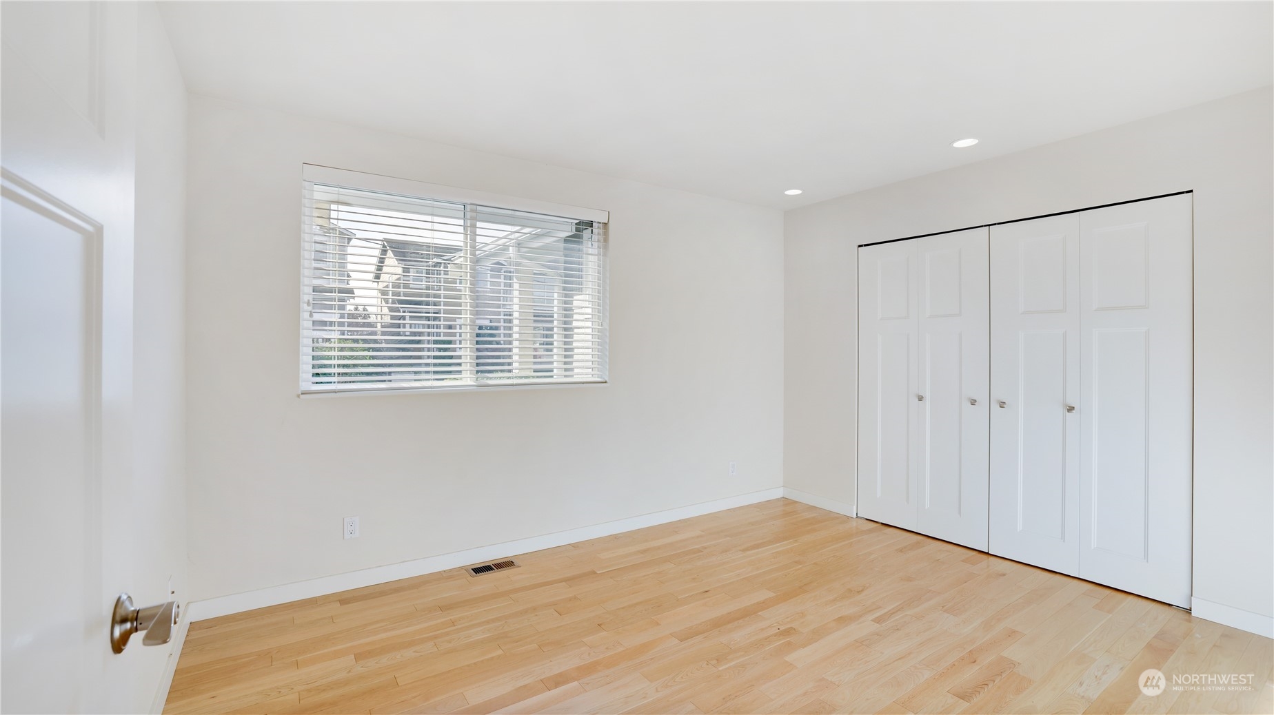 1008 North 33rd Place Renton, WA 98056 - Photo 23 of 30 a view of an empty room with wooden floor and a window