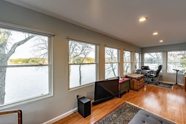 a living room with furniture and a floor to ceiling window