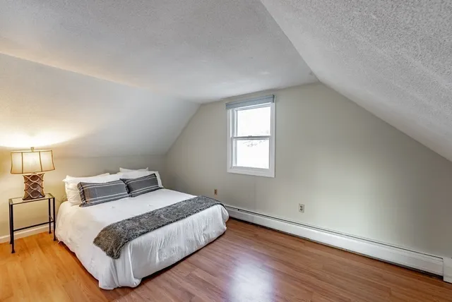 a bedroom with a bed and a night stand