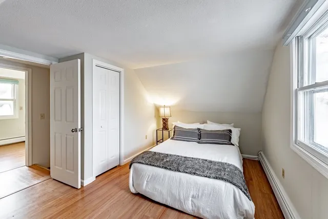a bedroom with a bed and window