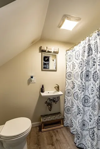 a bathroom with a toilet sink and shower