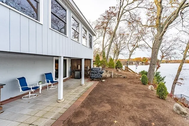 a view of a house with backyard porch and sitting area