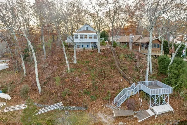 a backyard of a house with table and chairs