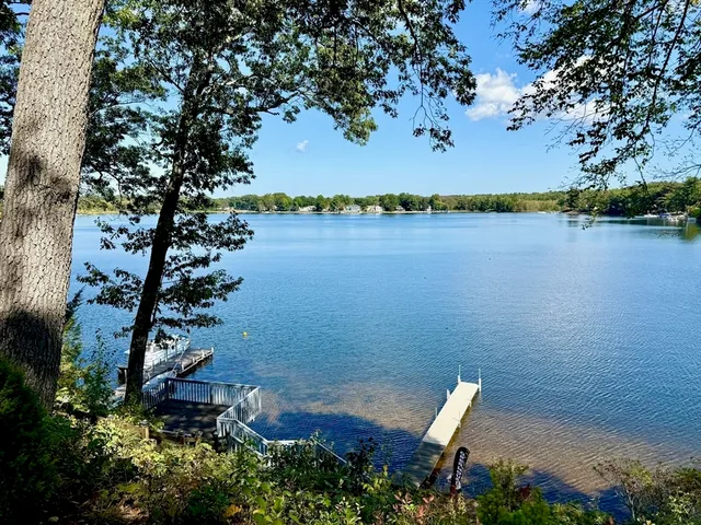 an aerial view of a house with a yard and lake view