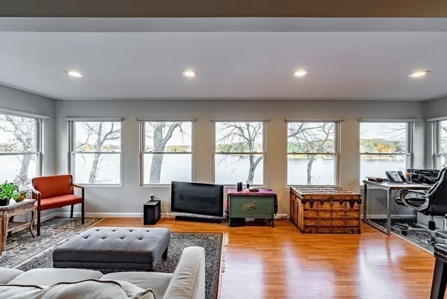 a living room with furniture and floor to ceiling windows