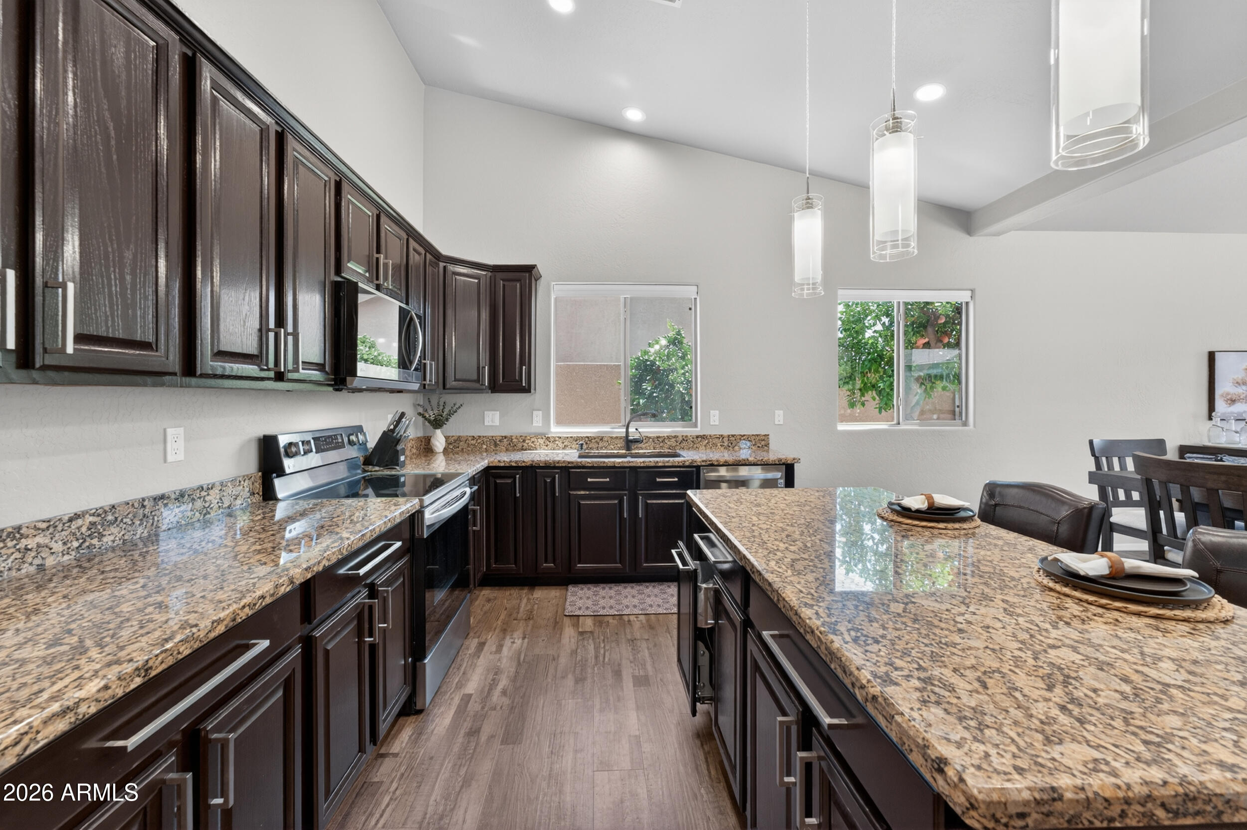 625 West Merrill Avenue Gilbert, AZ 85233 - Photo 12 of 48 a kitchen with granite countertop lots of counter top space a sink and appliances