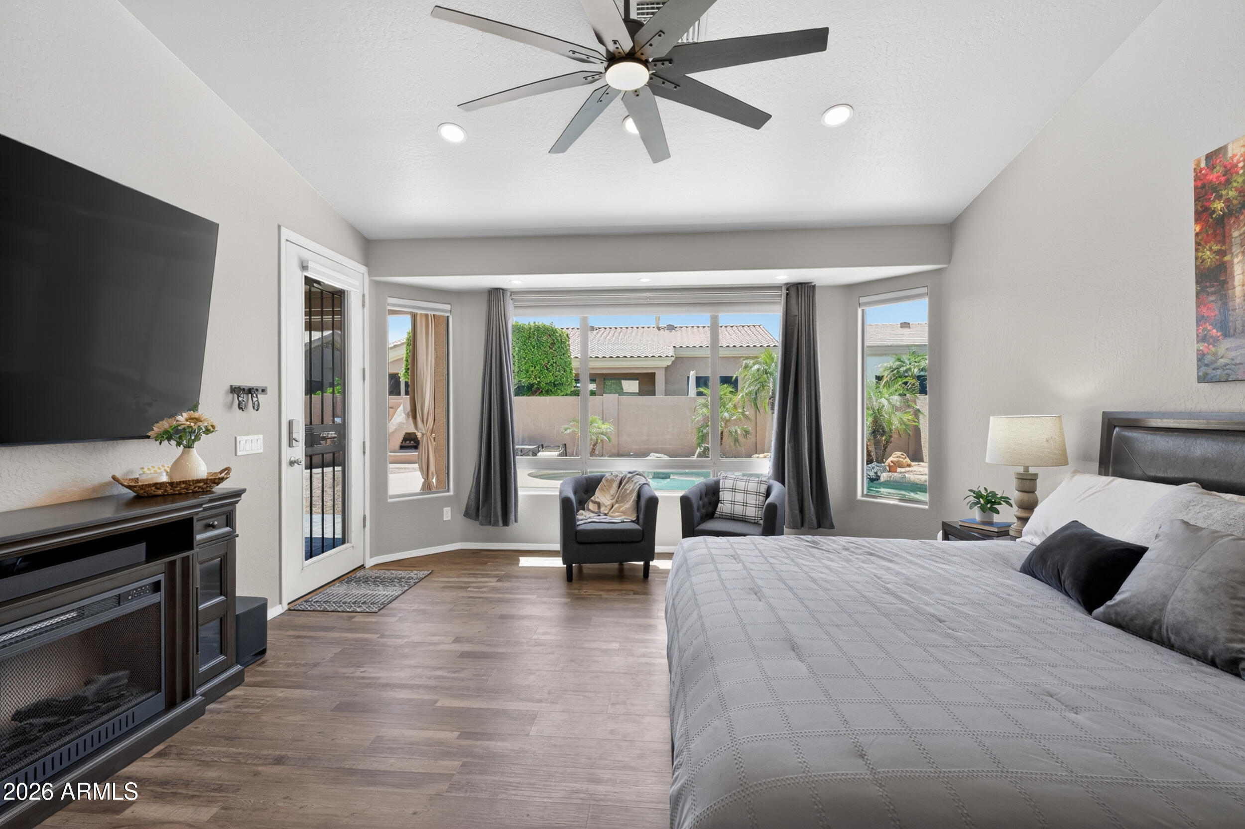 625 West Merrill Avenue Gilbert, AZ 85233 - Photo 16 of 48 a bedroom with a balcony a bed and a flat screen tv