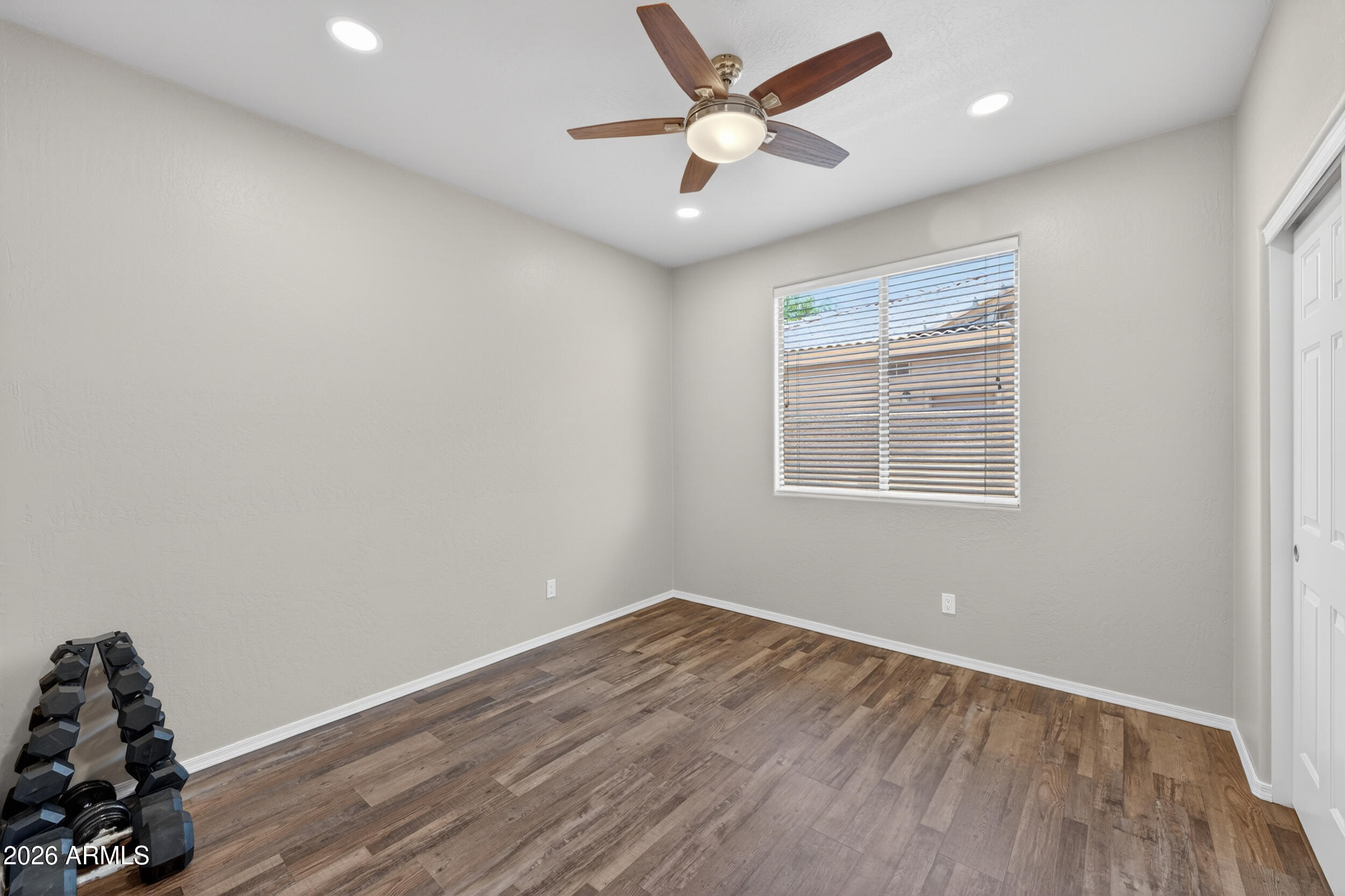 625 West Merrill Avenue Gilbert, AZ 85233 - Photo 31 of 48 an empty room with wooden floor and windows