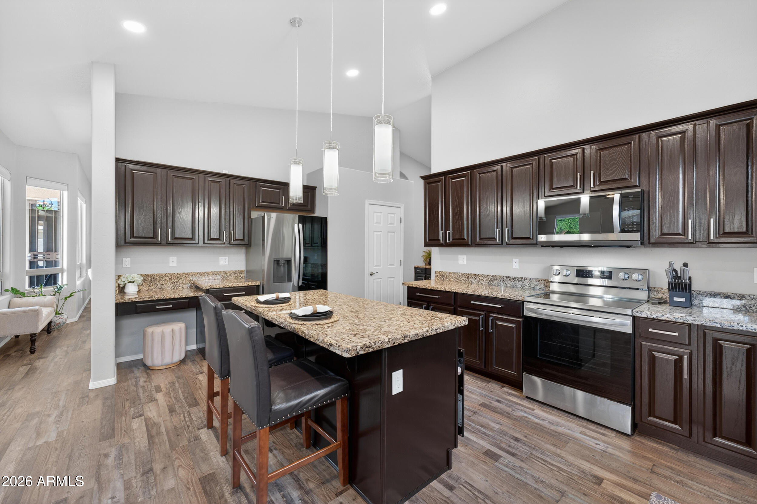 625 West Merrill Avenue Gilbert, AZ 85233 - Photo 10 of 48 a kitchen with stainless steel appliances granite countertop wooden cabinets a refrigerator a stove a sink and a stove