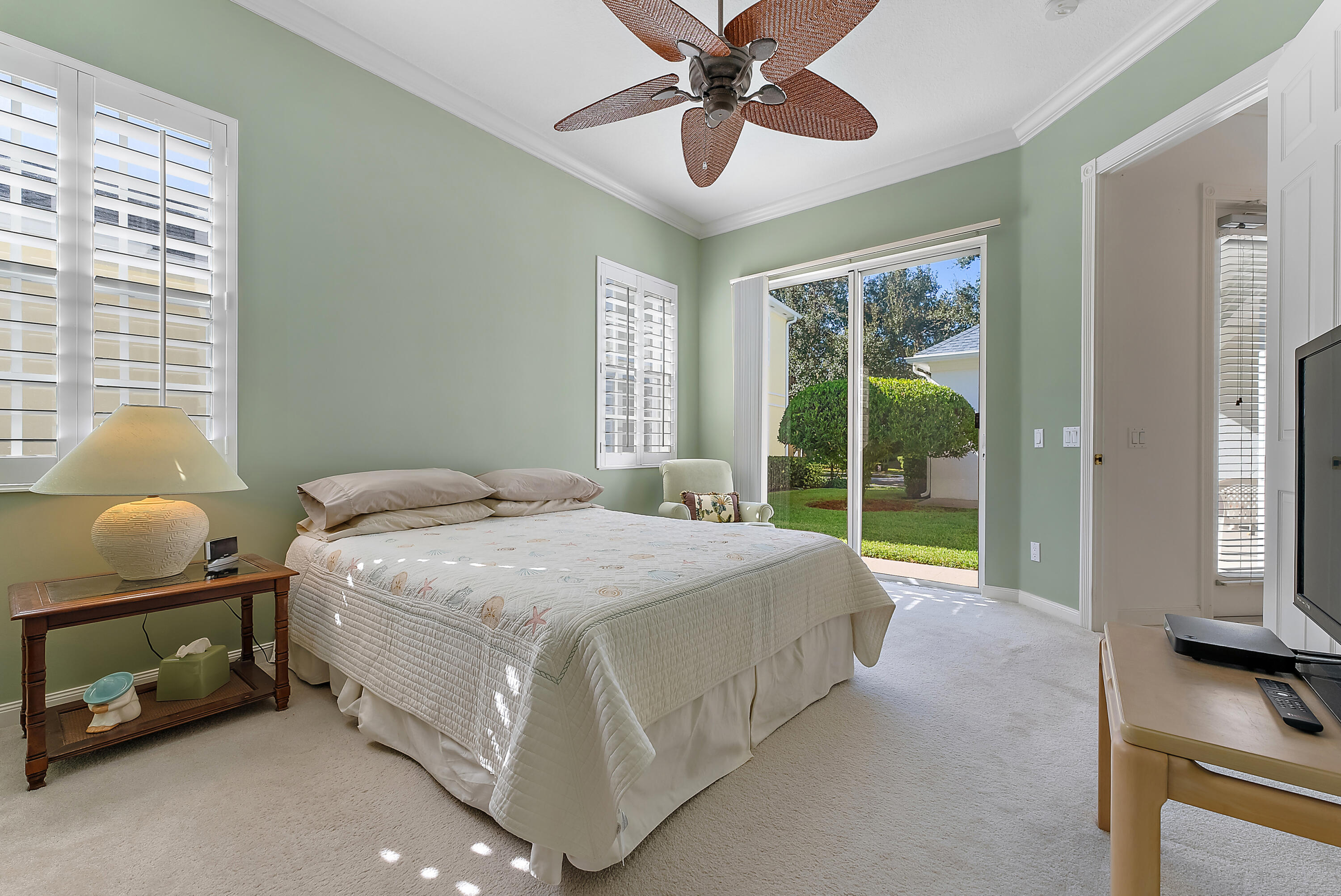 213 Barbados Drive Jupiter, FL 33458 - Photo 22 of 55 a spacious bedroom with a bed and a window