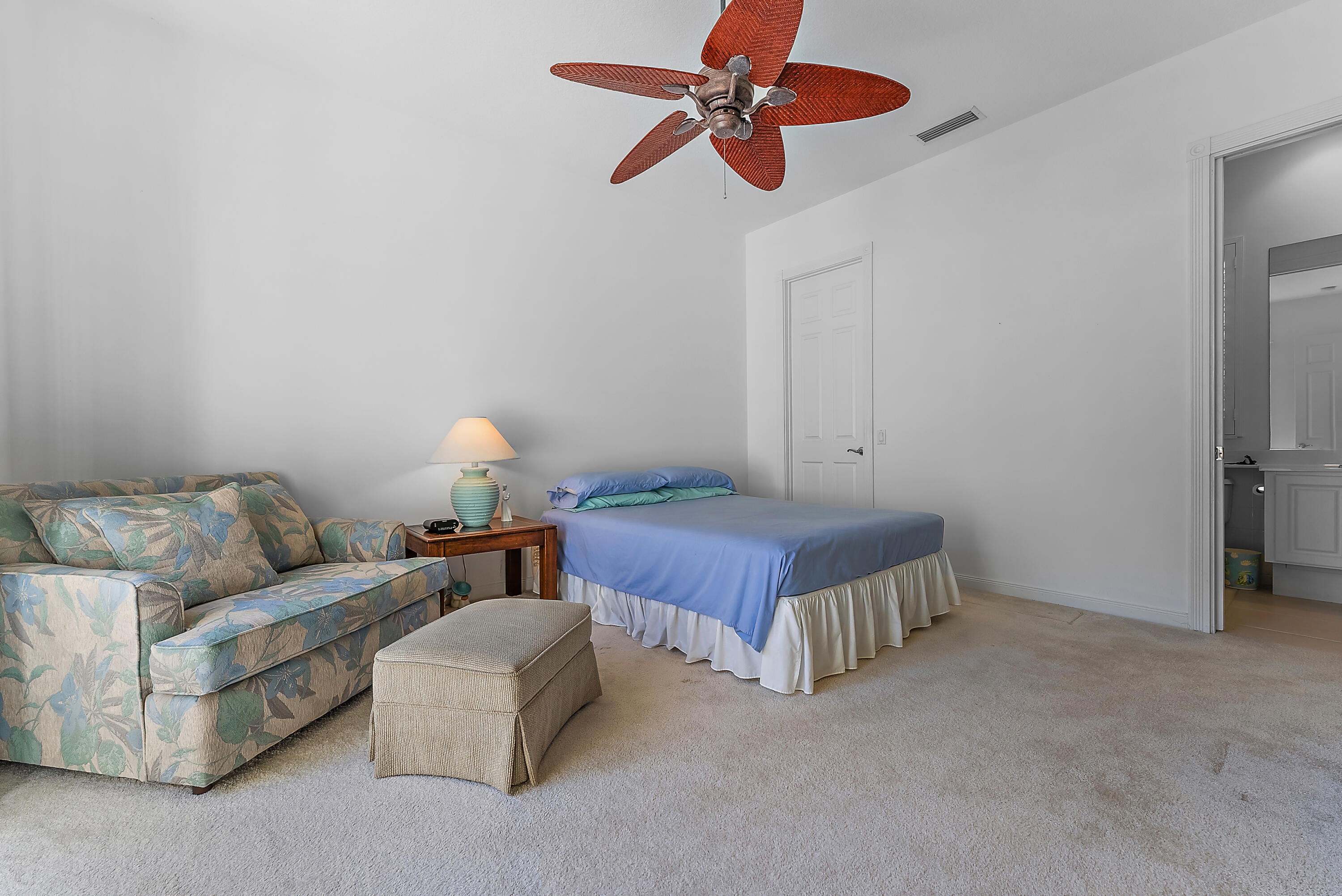 213 Barbados Drive Jupiter, FL 33458 - Photo 25 of 55 a bedroom with a bed and a chandelier