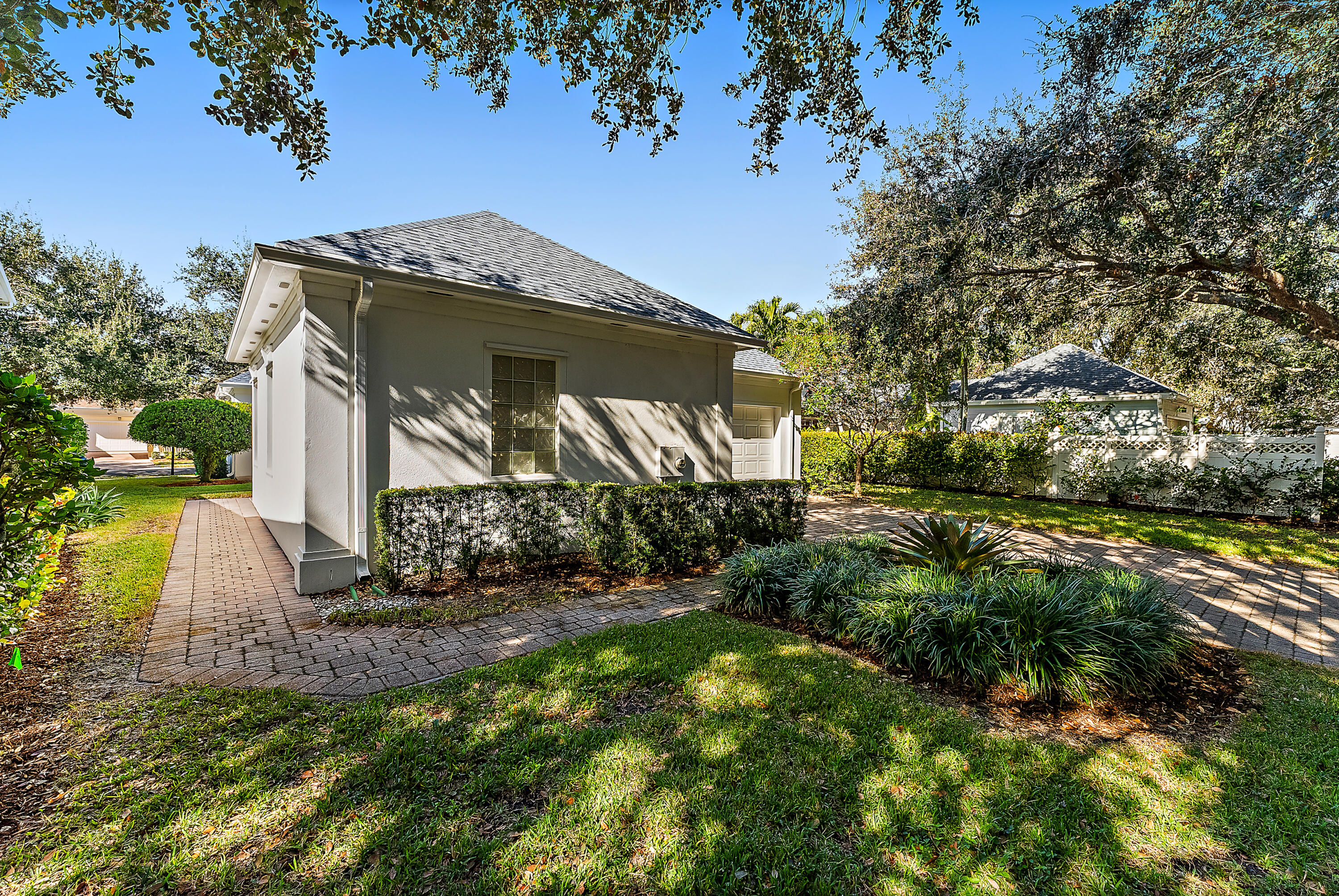 213 Barbados Drive Jupiter, FL 33458 - Photo 45 of 55 a front view of a house with a yard