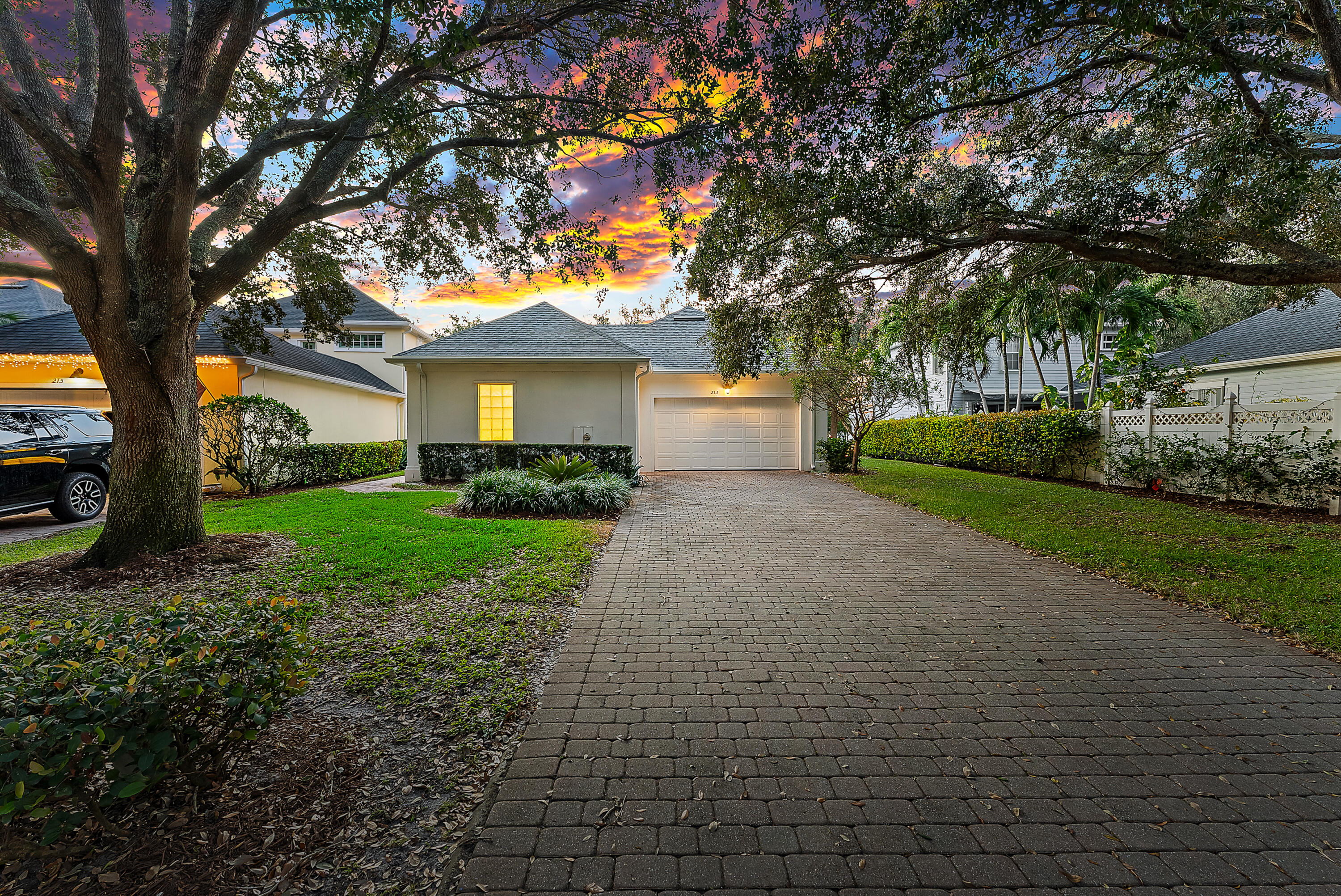213 Barbados Drive Jupiter, FL 33458 - Photo 48 of 55 a front view of a house with garden