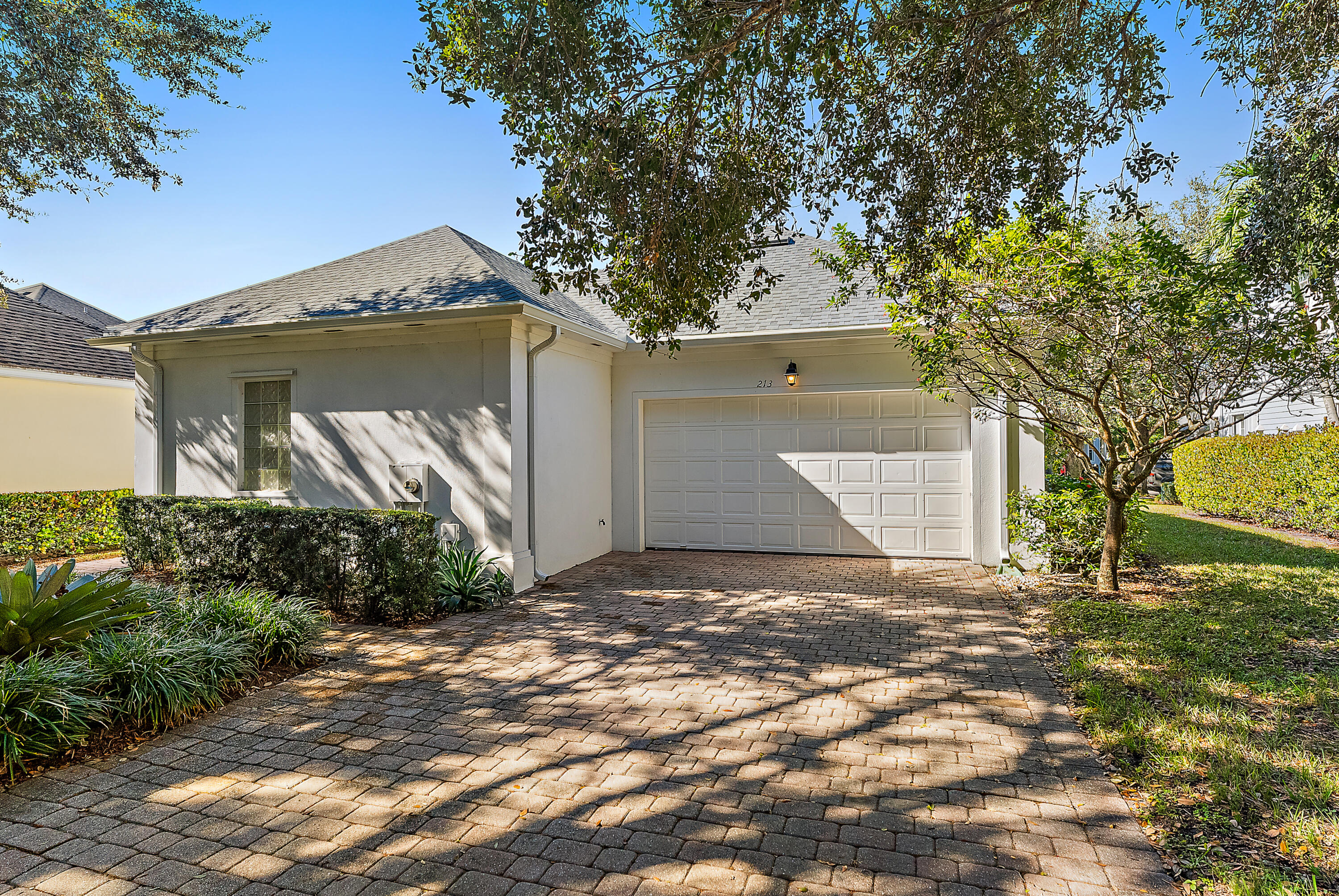 213 Barbados Drive Jupiter, FL 33458 - Photo 49 of 55 a front view of a house with garden