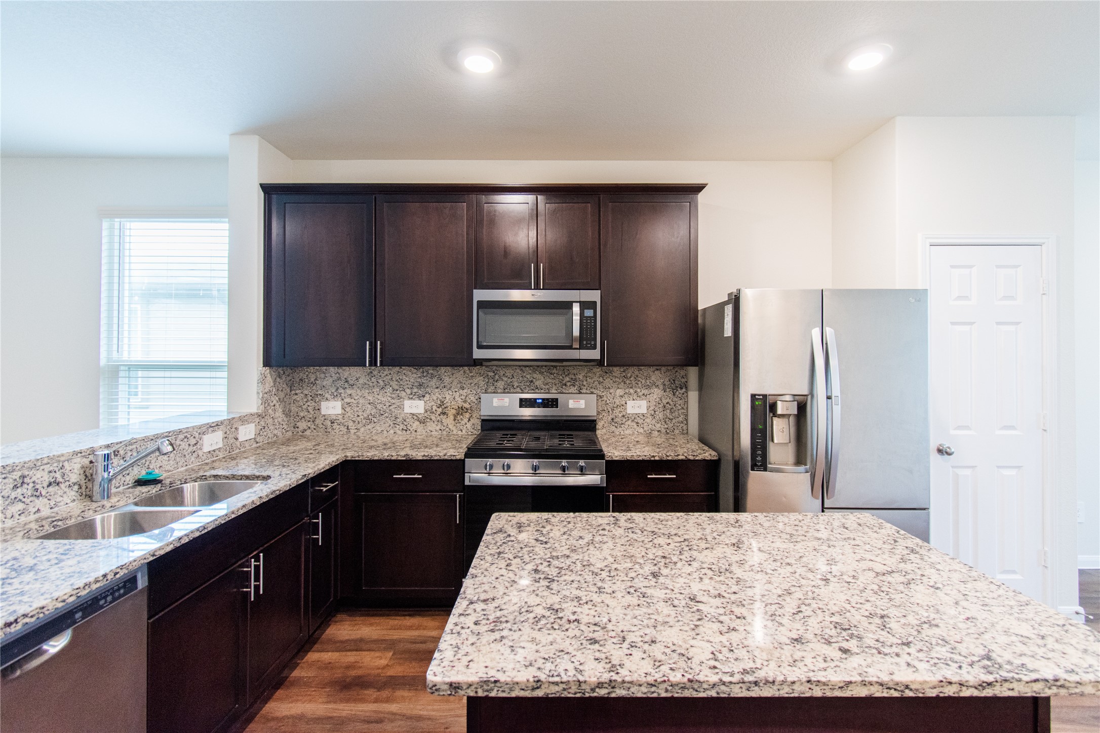 a kitchen with a sink stove and refrigerator