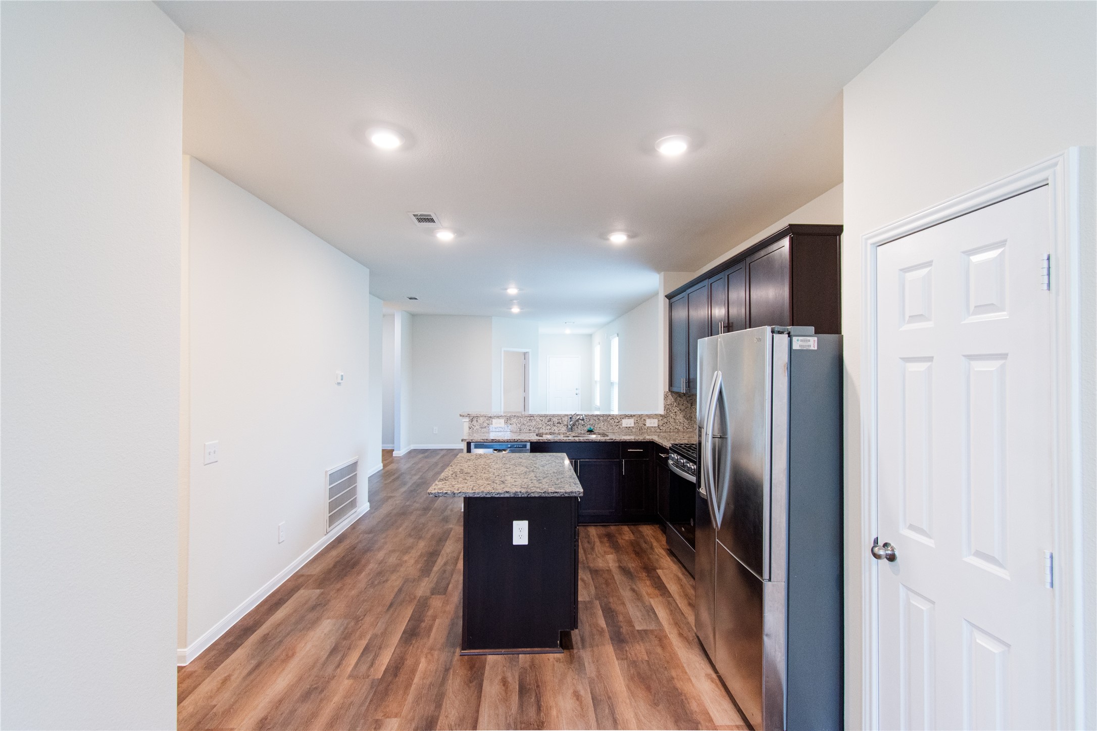6938 Hobby Wind Ridge Drive Houston, TX 77075 - Photo 11 of 30 a kitchen with a refrigerator and wooden floor