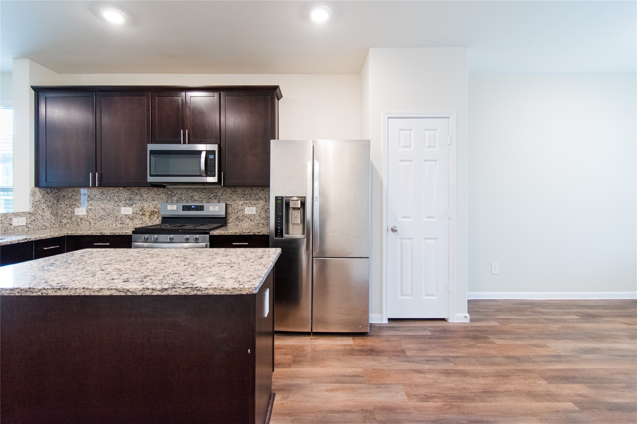 6938 Hobby Wind Ridge Drive Houston, TX 77075 - Photo 12 of 30 a kitchen with kitchen island granite countertop cabinets stainless steel appliances and a counter top space
