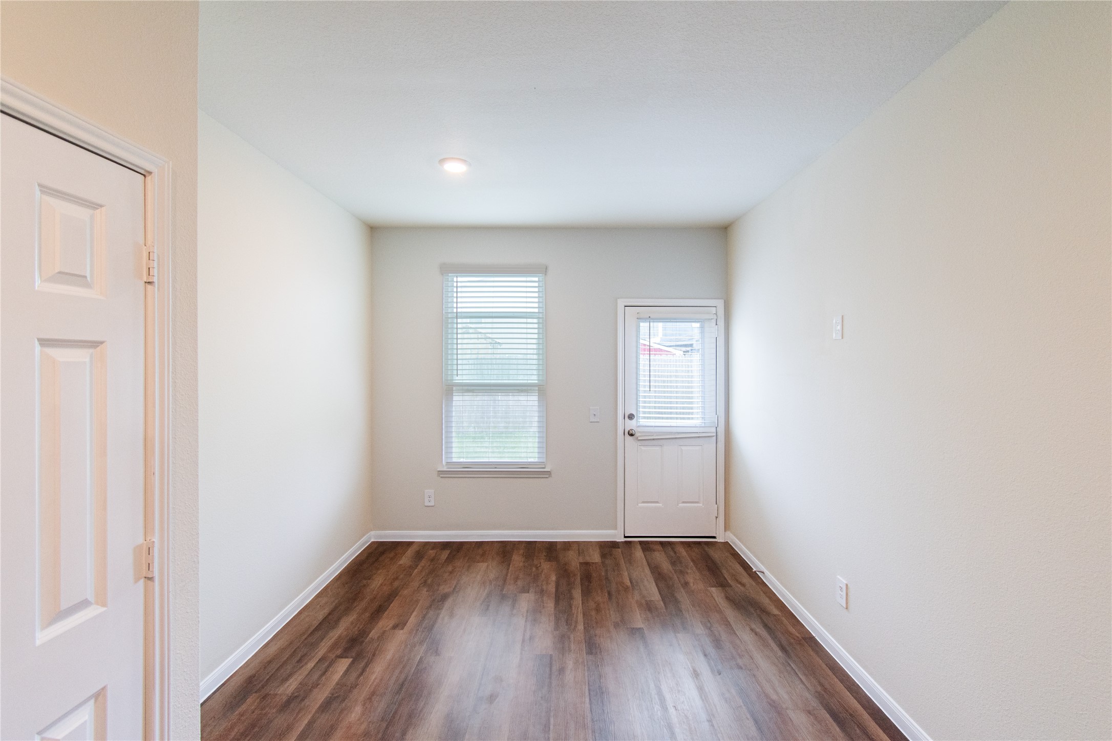 6938 Hobby Wind Ridge Drive Houston, TX 77075 - Photo 16 of 30 an empty room with wooden floor and windows
