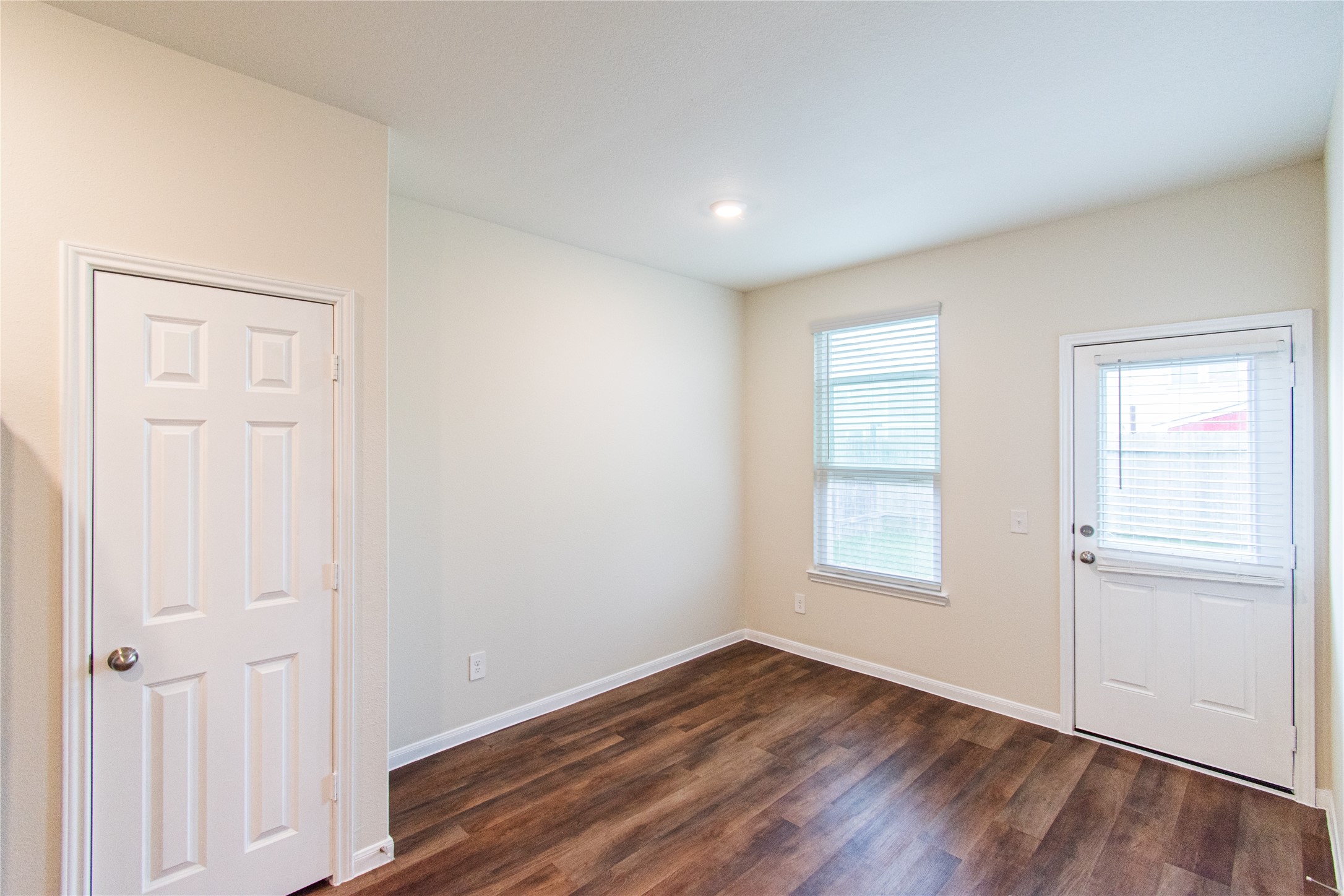 6938 Hobby Wind Ridge Drive Houston, TX 77075 - Photo 28 of 30 an empty room with wooden floor and windows