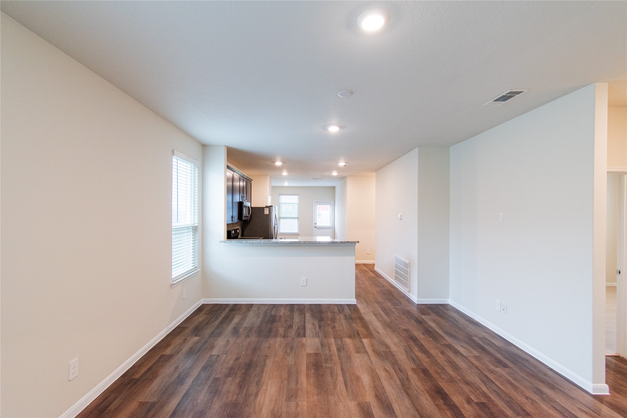 6938 Hobby Wind Ridge Drive Houston, TX 77075 - Photo 7 of 30 a view of storage and utility room with wooden floor