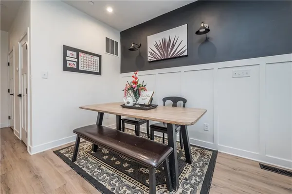 a view of a room with furniture and wooden floor