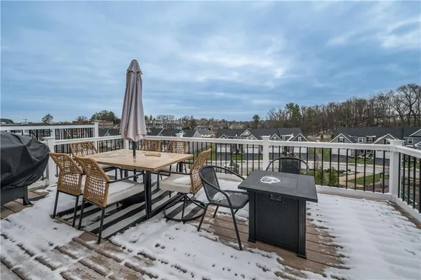 a view of a terrace with wooden benches and city view