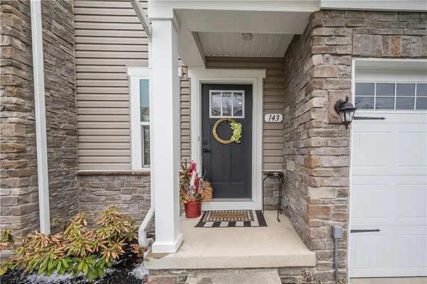 a front view of a house with a potted plant