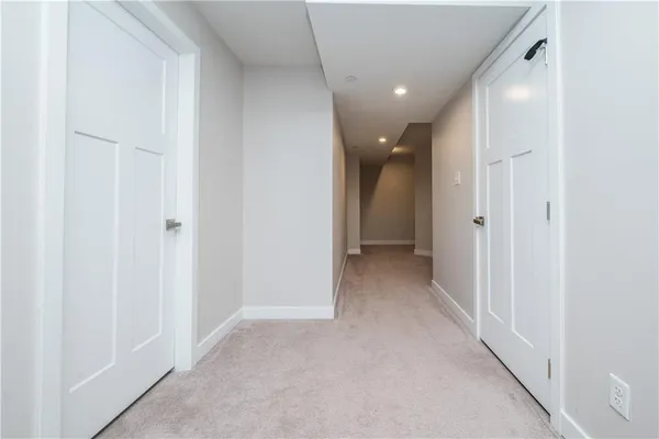 a view of a hallway with closet and a bathroom