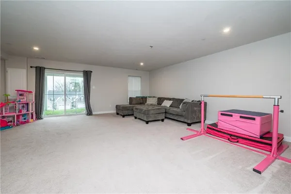 a living room with furniture and gym equipment